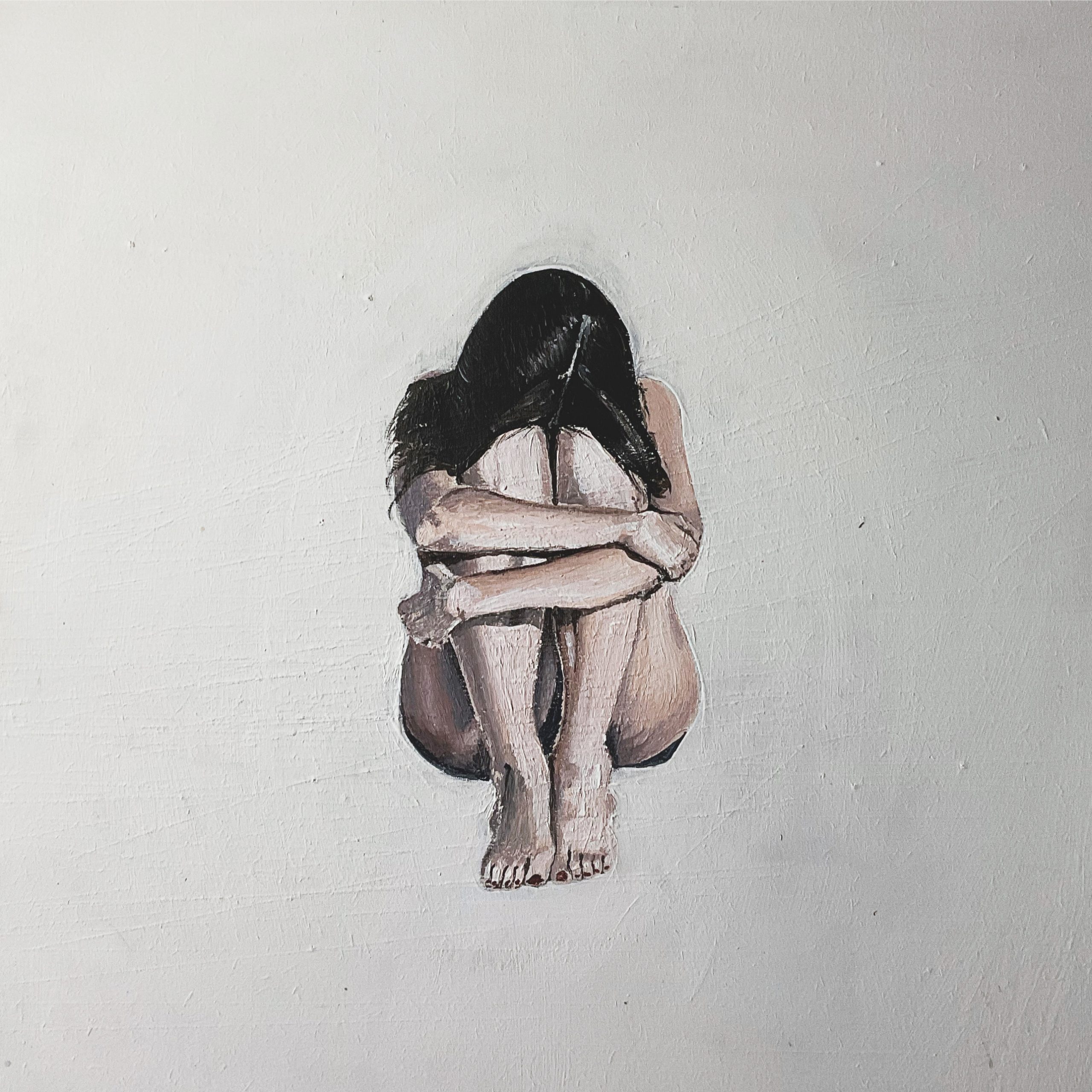 a painting of a woman sat in a foetal position representing how women can make themselves small to fit in or make others feel more comfortable.It also represents how women's voices can feel small in the world and how they sometimes struggle to take up their own space.